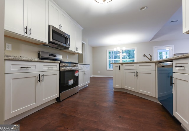 kitchen with hanging light fixtures, light stone counters, a notable chandelier, white cabinets, and appliances with stainless steel finishes