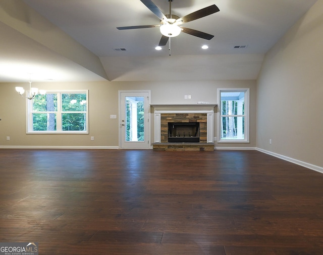 unfurnished living room with a stone fireplace, plenty of natural light, and lofted ceiling