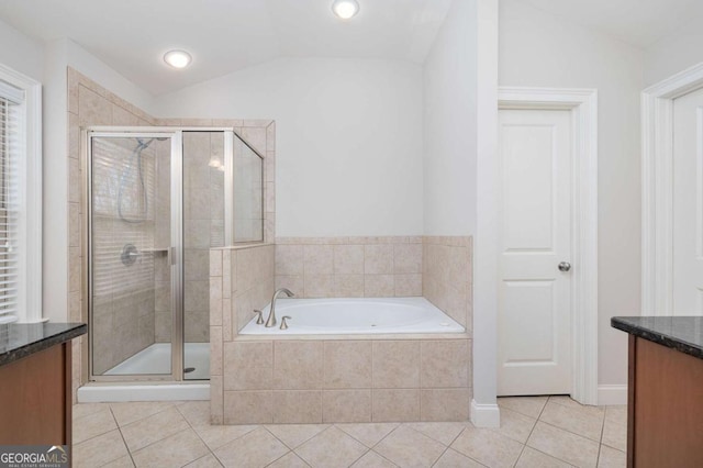 bathroom featuring tile patterned floors, vanity, lofted ceiling, and plus walk in shower