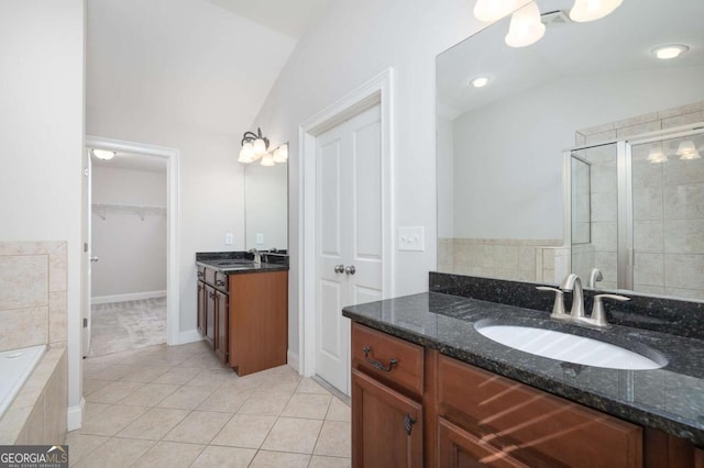 bathroom featuring separate shower and tub, tile patterned flooring, vanity, and lofted ceiling