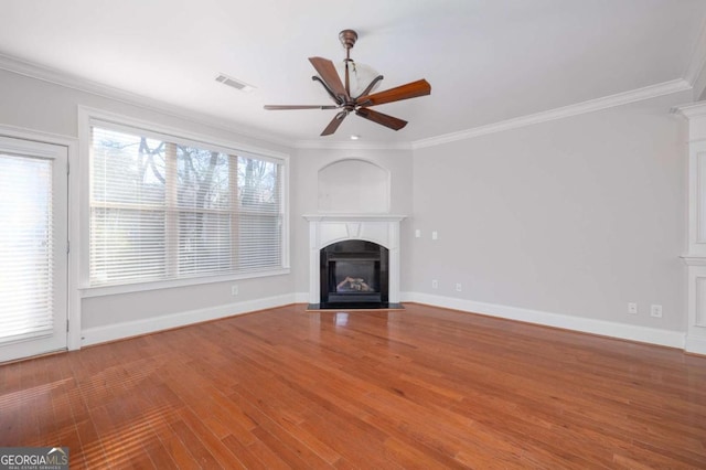 unfurnished living room with crown molding and a healthy amount of sunlight