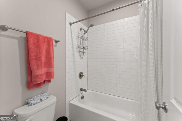 bathroom featuring shower / tub combo with curtain and toilet