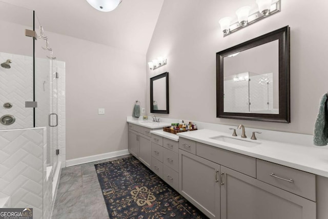 bathroom with vanity, a shower with door, and lofted ceiling