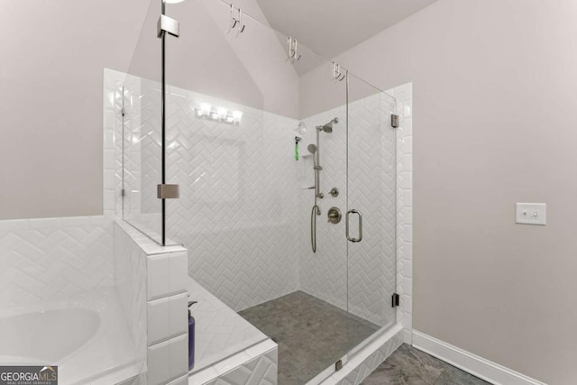 bathroom featuring shower with separate bathtub