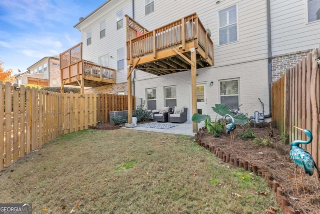 rear view of house featuring a lawn, an outdoor living space, a patio area, and a wooden deck