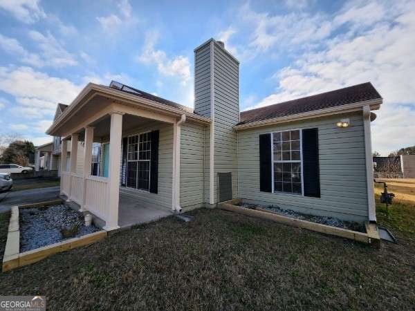 back of house with a yard