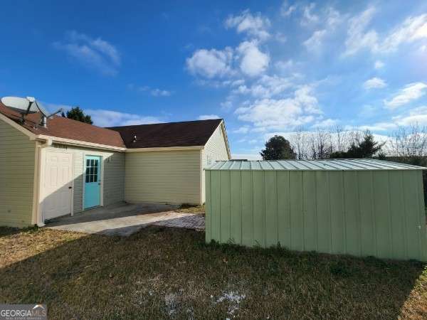 view of side of home with a patio area