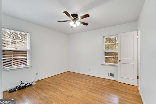 unfurnished room featuring light wood-type flooring, plenty of natural light, and ceiling fan