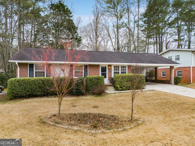 ranch-style house featuring a carport and a front yard