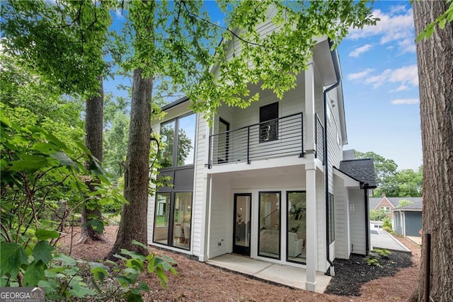 back of property featuring a balcony