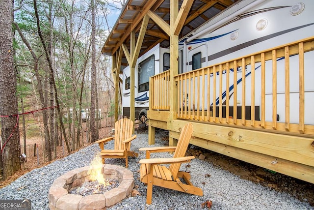 exterior space featuring a fire pit and a wooden deck