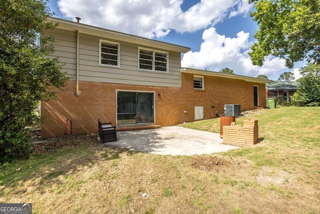 rear view of house with a patio, cooling unit, and a lawn