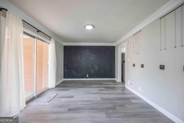 hall featuring ornamental molding and light wood-type flooring