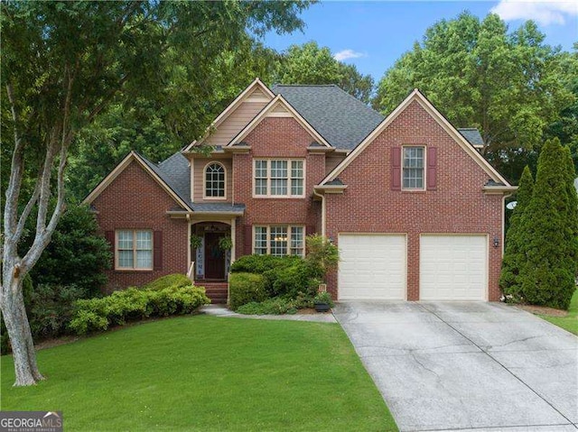 view of front of house featuring a garage and a front yard