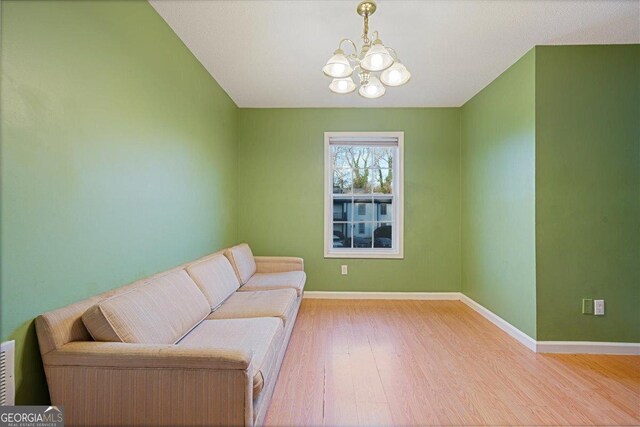 living area featuring a chandelier and light wood-type flooring