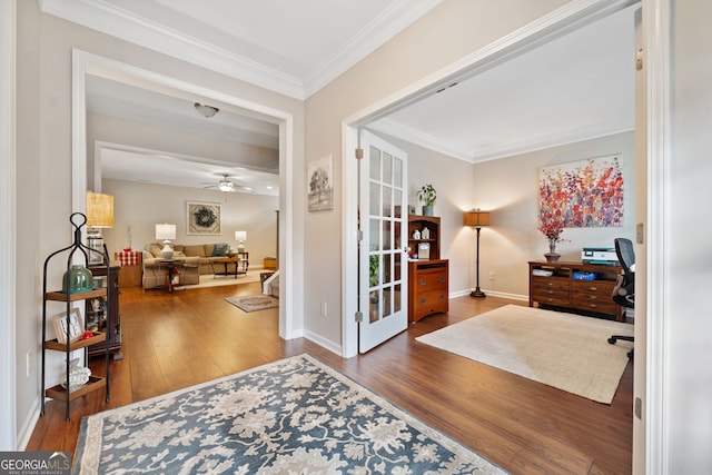 interior space with ceiling fan, crown molding, and dark wood-type flooring