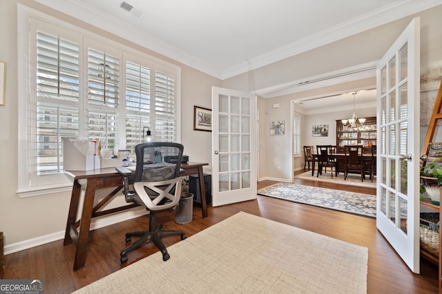 office space with a chandelier, french doors, dark hardwood / wood-style flooring, and ornamental molding