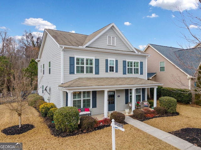 view of front of home featuring a front yard and a porch