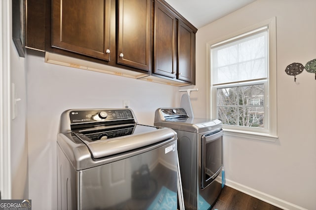 laundry room featuring dark hardwood / wood-style floors, cabinets, and independent washer and dryer