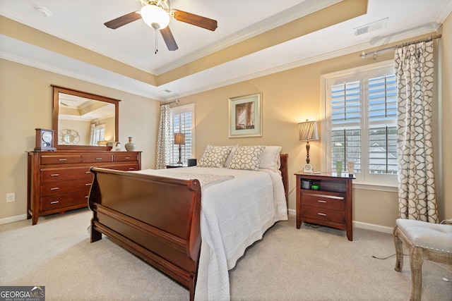 bedroom featuring light carpet, a raised ceiling, ceiling fan, and crown molding