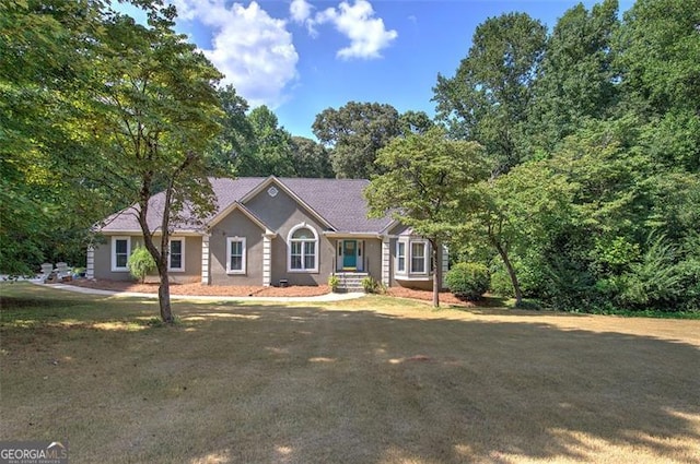 single story home featuring a front yard