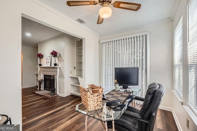 office with a textured ceiling, dark hardwood / wood-style floors, built in features, and crown molding