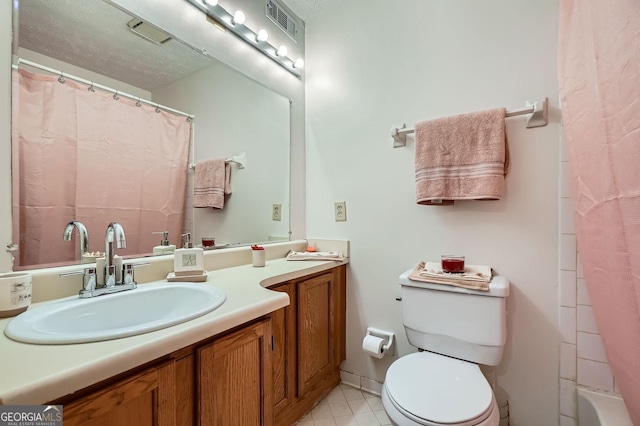 bathroom with tile patterned flooring, vanity, toilet, and curtained shower