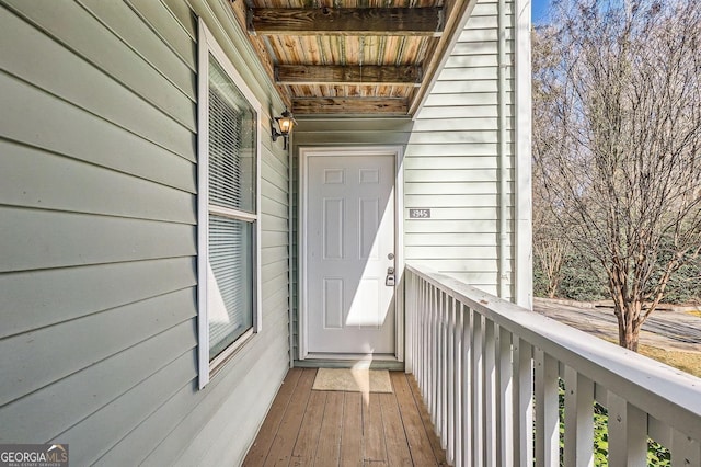 view of exterior entry featuring a balcony