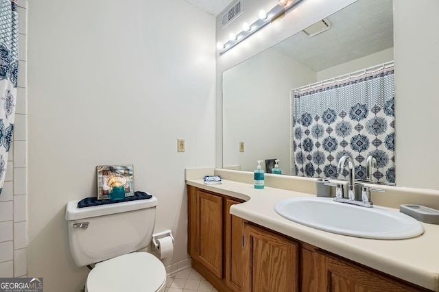 bathroom with curtained shower, tile patterned flooring, vanity, and toilet