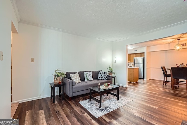 living room with a textured ceiling, crown molding, and dark wood-type flooring