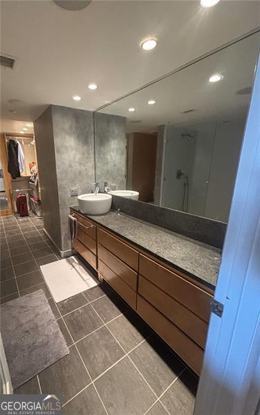 bathroom with vanity, tile patterned floors, and walk in shower