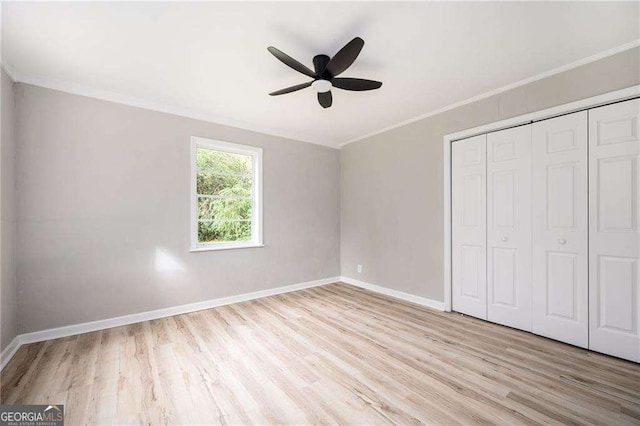 unfurnished bedroom featuring a closet, ceiling fan, crown molding, and light hardwood / wood-style floors