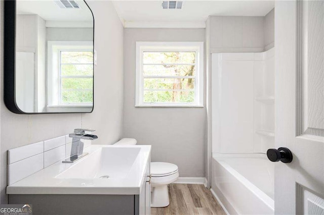 full bathroom with vanity, hardwood / wood-style flooring, toilet, and a wealth of natural light