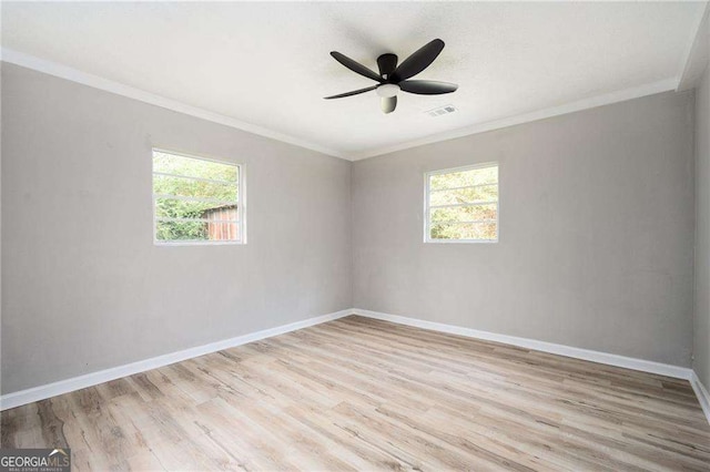 empty room with ceiling fan, light wood-type flooring, and crown molding