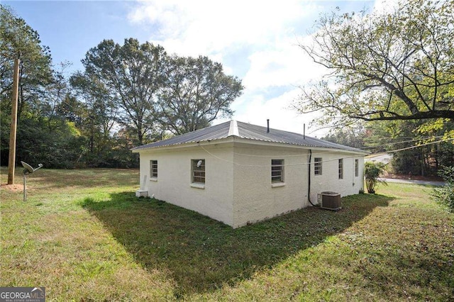 view of home's exterior featuring a yard and cooling unit