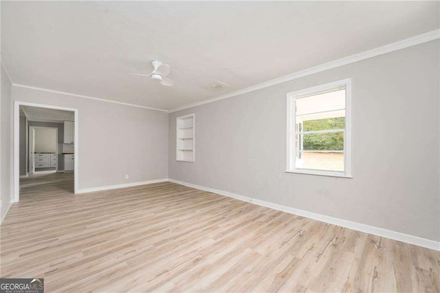 unfurnished room featuring crown molding, built in features, ceiling fan, and light wood-type flooring