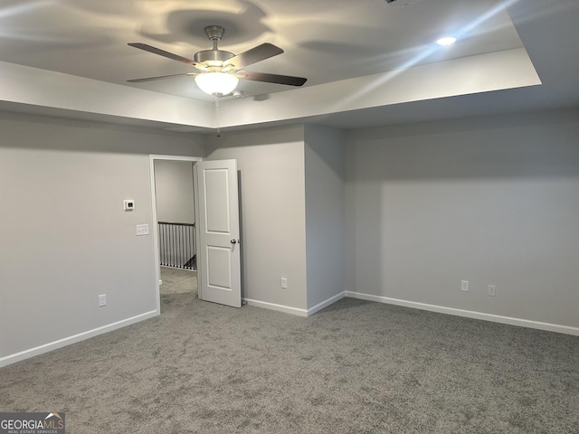 basement featuring carpet flooring and ceiling fan