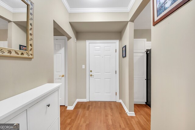 exercise room featuring a raised ceiling, ceiling fan, and crown molding