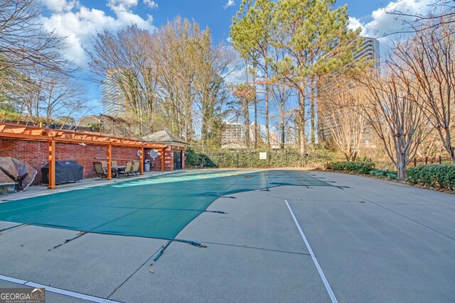 view of swimming pool featuring a patio area