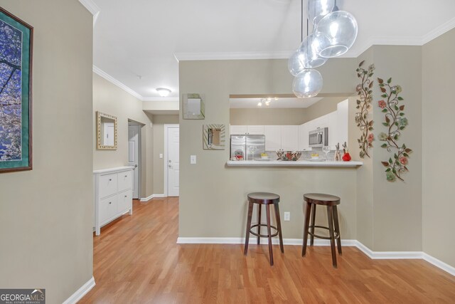 living room featuring wood-type flooring, built in features, and crown molding