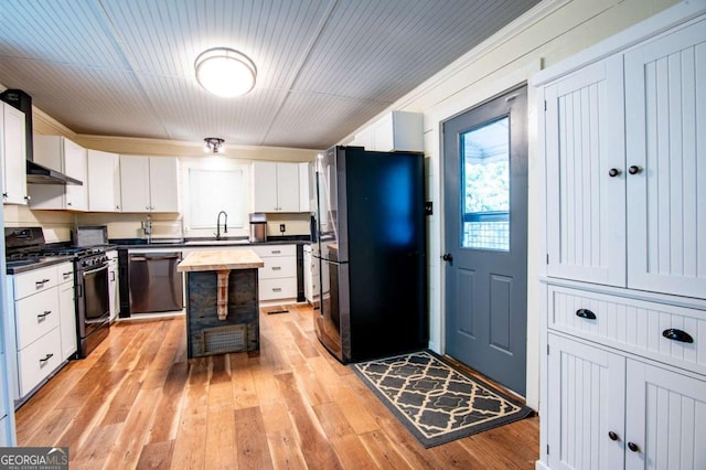 kitchen featuring white cabinets, sink, light wood-type flooring, and stainless steel appliances