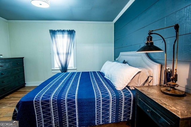 bedroom featuring hardwood / wood-style floors and ornamental molding