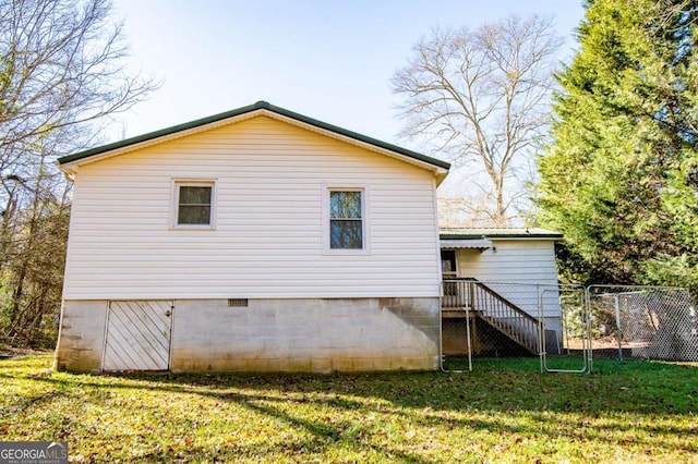 back of property featuring a lawn