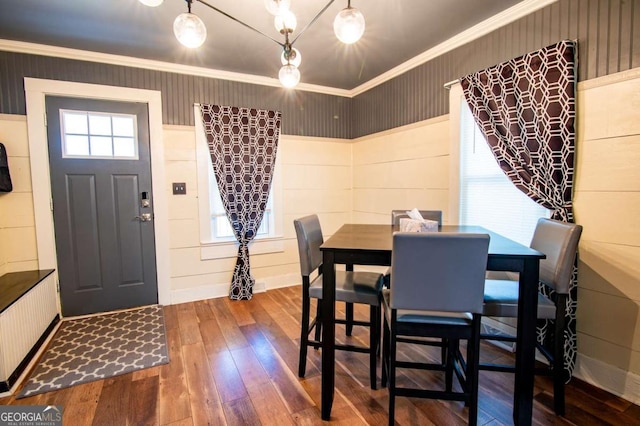 dining area featuring radiator heating unit, hardwood / wood-style flooring, plenty of natural light, and ornamental molding