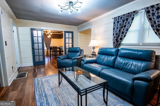 living room with french doors, an inviting chandelier, ornamental molding, and hardwood / wood-style floors