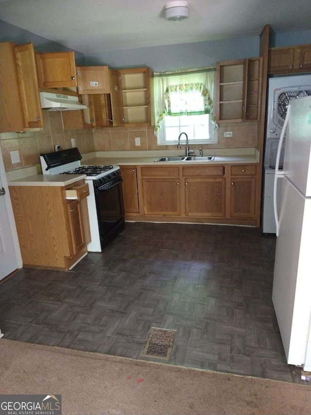 kitchen featuring tasteful backsplash, white appliances, dark parquet floors, exhaust hood, and sink