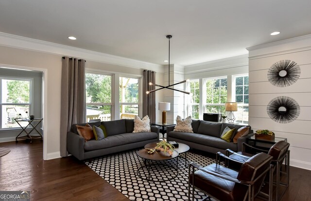 living room featuring a chandelier, dark hardwood / wood-style floors, and ornamental molding