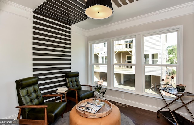 living area with a wealth of natural light, dark hardwood / wood-style floors, and ornamental molding