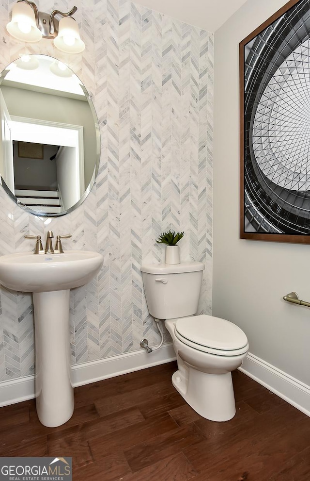 bathroom featuring wood-type flooring and toilet