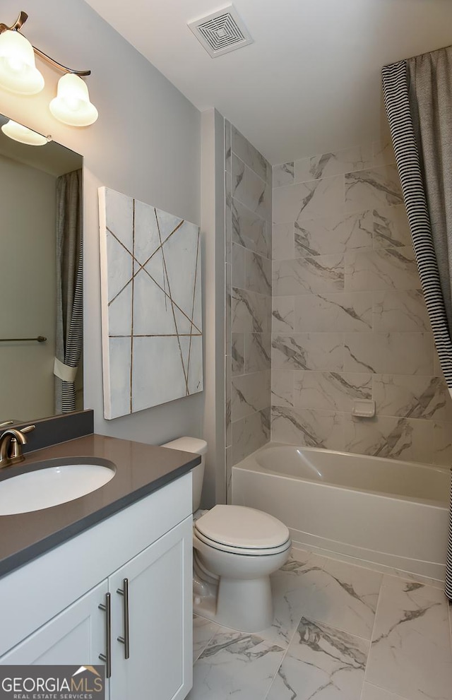 full bathroom with vanity, toilet, and tiled shower / bath